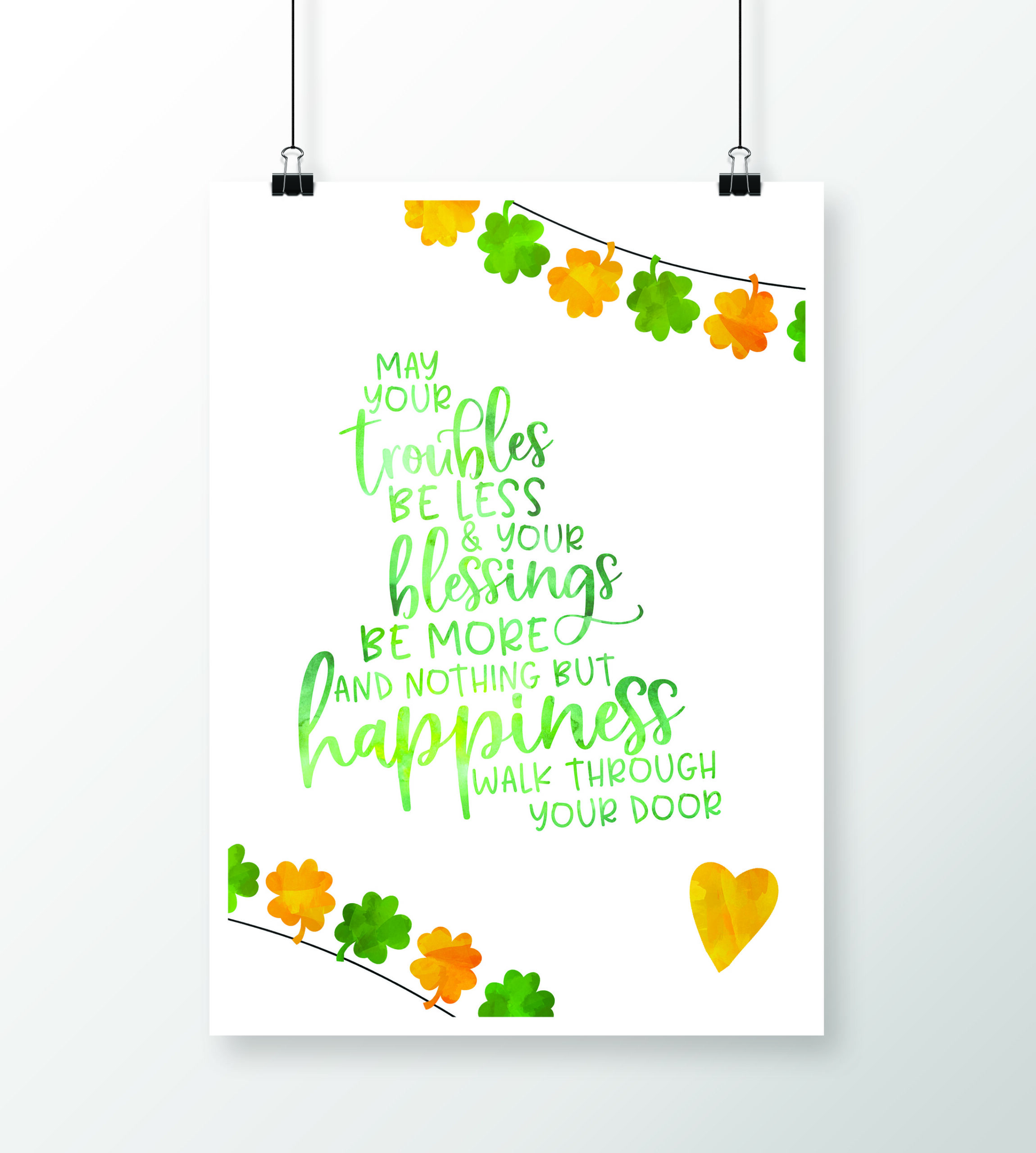 A white poster with green and orange watercolor text: May your troubles be less and your blessings be more and nothing but happiness walk through your door. Features clovers and a yellow heart, with clover garlands at the top and bottom.