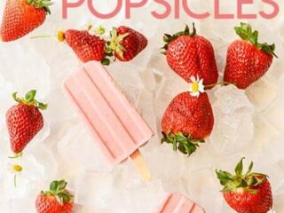 Image of pink popsicles on a bed of ice, surrounded by fresh strawberries and small white flowers. Text at the top reads STRAWBERRIES & CREAM POPSICLES.
