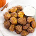 Pumpkin spice pretzel bites coated in cinnamon sugar on a white plate