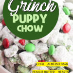 Bowl of Grinch puppy chow with text 7 Ingredient Grinch Puppy Chow and ingredients Chex, almond bark, peanut butter, hearts, powdered sugar