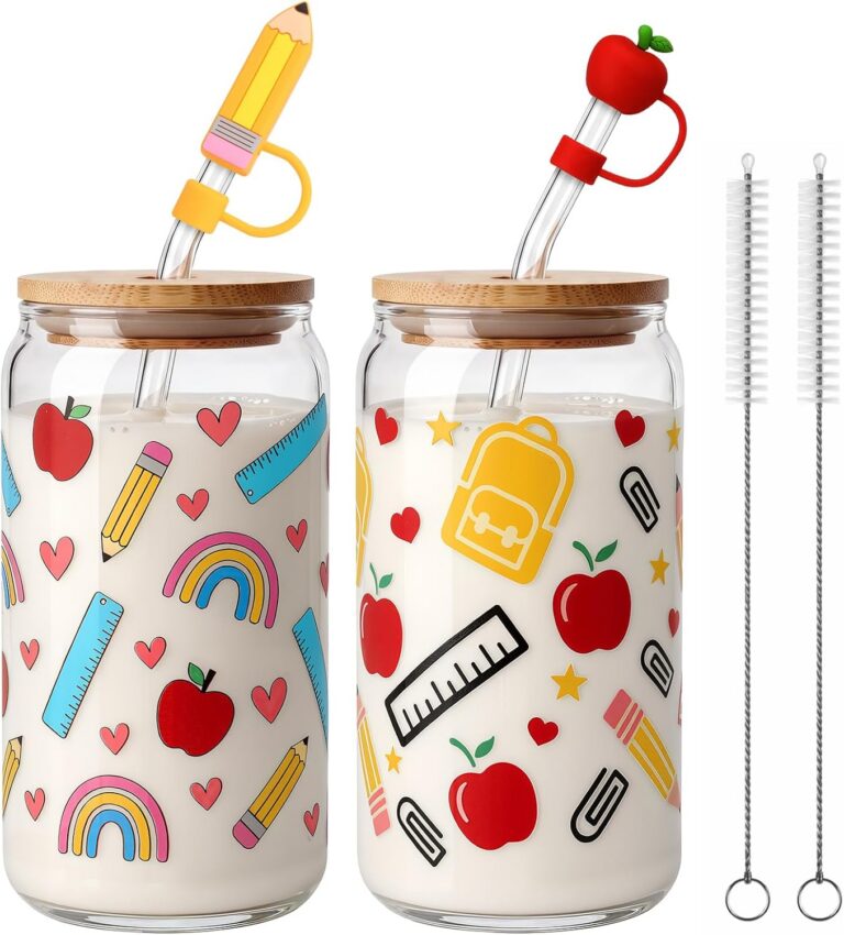 Two glass cups with apple and pencil designs, bamboo lids and straws