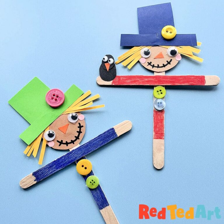 Popsicle stick scarecrow craft with a paper face, hair and hat