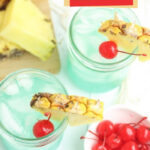 Blue mocktail with pineapple and cherries