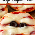 Easy mummy face pizzas with olive eyes on a baking sheet