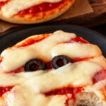 Four ingredient mummy face bagel pizzas ready in 15 minutes