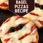 Mummy face pizzas on bagel halves with string cheese bandages and olive eyes, with text reading 15 Minute Mummy Face Bagel Pizzas Recipe