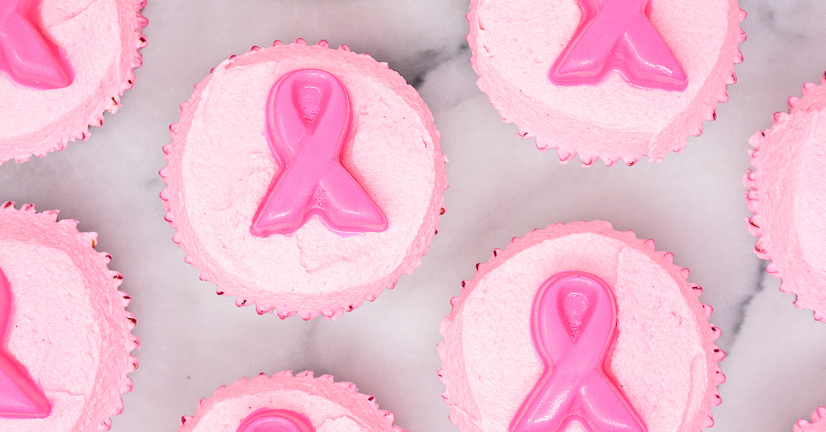 Pink velvet cupcakes with pink frosting and pink chocolate ribbon toppers