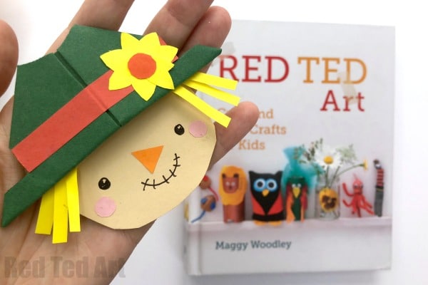 Paper corner bookmark decorated as a scarecrow with a hat and yellow paper hair