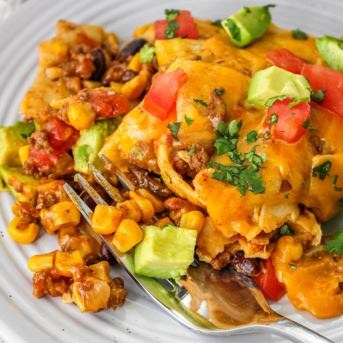 Slow cooker Mexican casserole with ground beef, tortillas and melted cheese