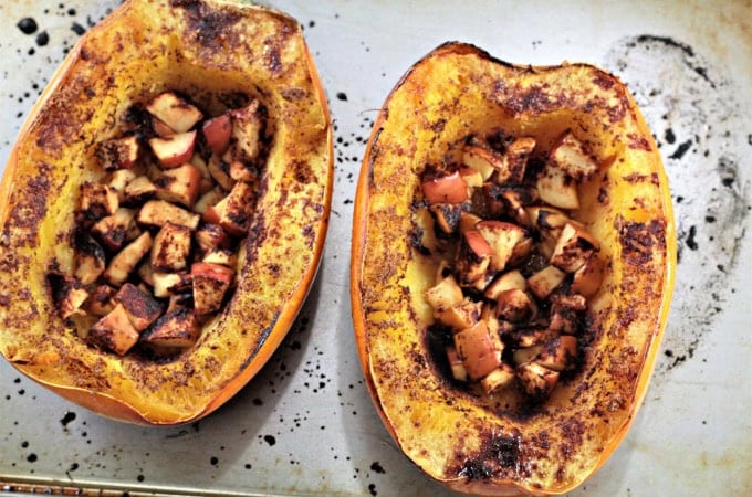 Roasted spaghetti squash halves filled with cinnamon brown sugar apples